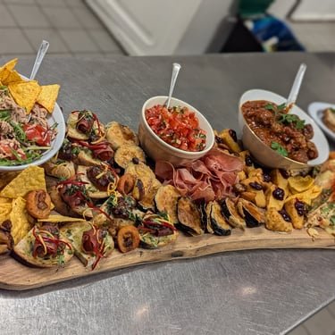 A generous sharing table of dishes prepared by Melvin